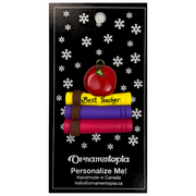 Stack of books and red apple teacher appreciation ornament, on display backing card.
