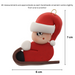 Small figure in red outfit and festive hat riding on brown toboggan ornament, graphed to show size (6x7cm).