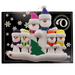 Family ornament with 6 white snowmen in bright scarves, with green Christmas tree, on display card backing.